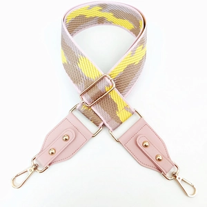 Adjustable leopard print bag strap with pink leather ends and gold metal buckles