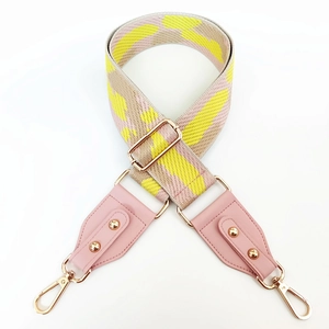 Adjustable wide woven shoulder strap with pink leather ends and gold metal clips