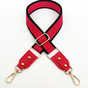 Adjustable red wide shoulder strap with black Greek key pattern and gold metal hooks
