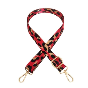 Detail of red leopard print nylon strap with gold lobster clasps and metal adjustment buckle
