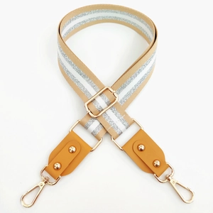 Adjustable beige fabric guitar strap with silver glitter stripes and gold rivet details