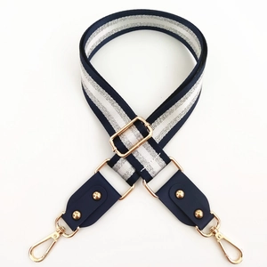 Adjustable dark blue and silver striped bag strap with golden metal swivel hooks