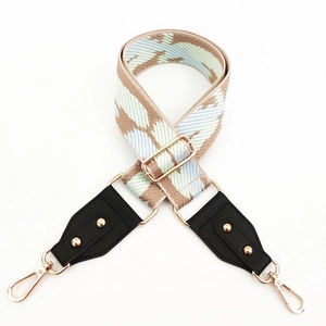Close-up of colorful woven shoulder strap with gold studs and lobster clasps