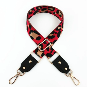 Detail of red leopard print wide bag strap with gold lobster clasps and hardware