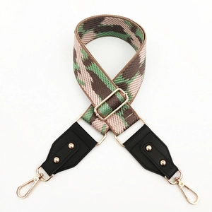 Detail of adjustable camouflage wide shoulder strap with premium gold metal hardware hooks