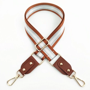 Detail of adjustable brown and silver striped strap with gold rivets and lobster clasps