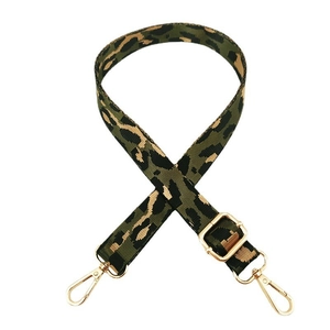 Adjustable leopard print nylon handbag strap with gold metal buckles on white background