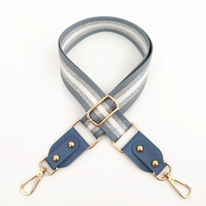 Adjustable grey and silver metallic striped shoulder strap with gold rivets and leather ends