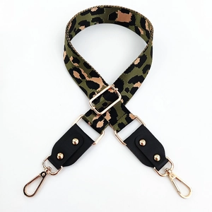 Detail of adjustable leopard print bag strap with golden hardware and leather ends