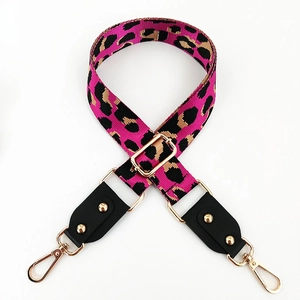 Detail of adjustable pink leopard print bag strap with golden metal lobster clasps