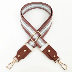 Detail of adjustable woven wide strap with silver metallic thread and gold rivets