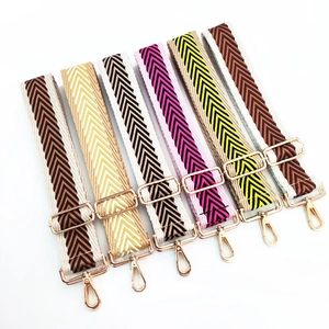 Macro shot of colorful woven canvas replacement bag straps with gold metal hardware