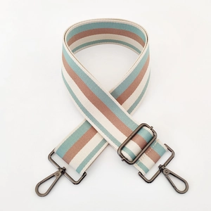 Detailed view of striped canvas strap with tiffany green, beige, and pink woven patterns