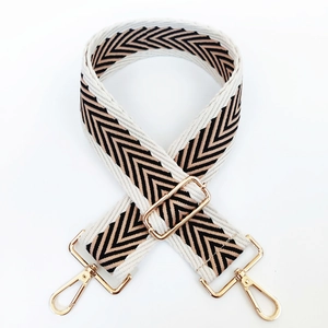 Detail showing the adjustable gold metal buckle and woven chevron pattern of the bag strap