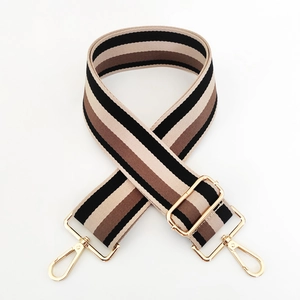 Detail of 5cm wide striped canvas bag strap with light gold metal swivel hooks and buckles