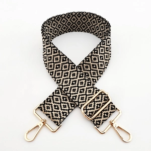 Detail of colorful jacquard wide bag strap with geometric patterns and golden lobster clasp