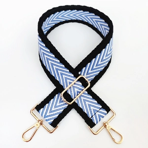 Close-up of a blue and white chevron woven strap with golden metal lobster clasps