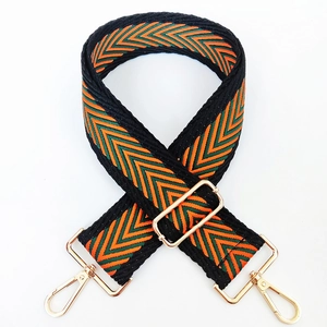 Adjustable woven shoulder strap with orange and green chevron patterns and gold hardware