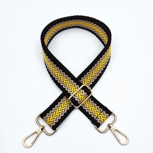 Close-up of a 3.8cm colorful woven bag strap with golden metal lobster clasps and buckles