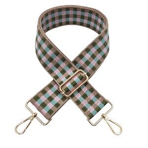 Close-up of woven checkered wide strap with pink, green, and blue patterns and gold buckles