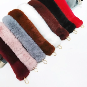 Detail of colorful faux fur bag straps with gold metal hooks for handbags