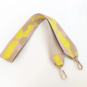 Macro shot of colorful cloud-pattern nylon wide strap with gold metal lobster clasps