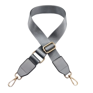 Adjustable grey nylon bag strap with gold lobster clasps and leather detailing