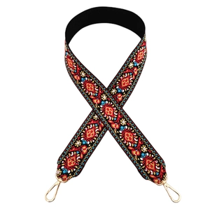 Close-up of ethnic geometric jacquard strap with red and blue patterns and gold clasps