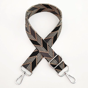 Detail of wide woven strap with geometric V-pattern and silver metal adjustment buckles