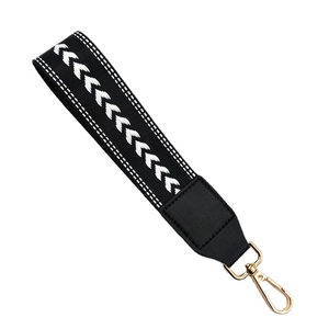 Short wide black and white chevron patterned handbag strap with gold metal spring clasp