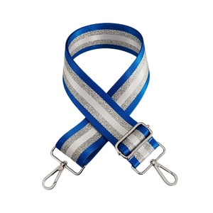 Close-up of shiny navy blue and silver stripe fabric bag strap with metallic hardware