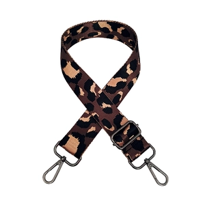 Detail of leopard jacquard wide shoulder strap with gunmetal swivel hooks and buckles