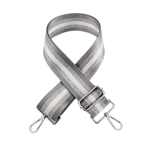 Close-up of adjustable woven bag strap with silver metallic stripes and lobster clasps