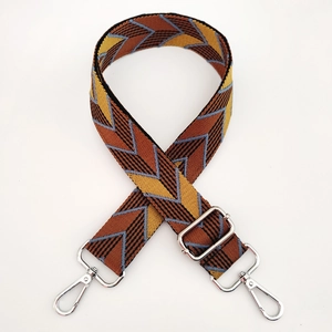 Close-up of adjustable woven shoulder strap with colorful geometric V-pattern and silver metal hardware