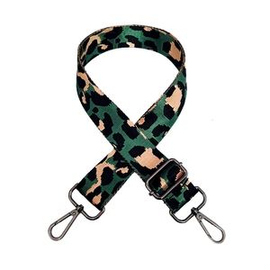 Detail view of adjustable leopard print bag strap with gunmetal hardware buckles