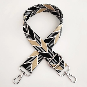 Close-up of geometric V-pattern woven strap with adjustable silver metal hooks
