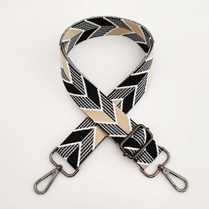 Detail of adjustable geometric herringbone woven strap with dark gunmetal hardware clips