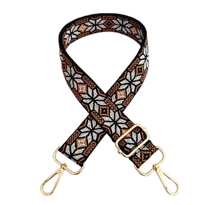 Detail of vintage geometric snowflake jacquard bag strap with gold metal lobster clasps