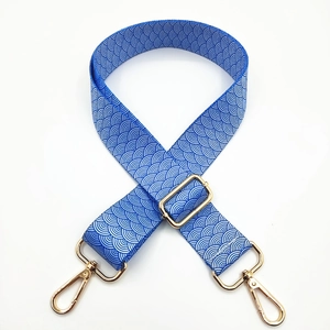Adjustable blue ethnic shoulder strap with white wave pattern and gold metal hardware