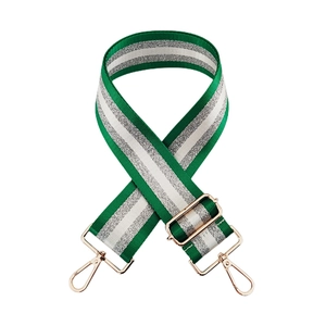 Detail of adjustable nylon bag strap with green and silver stripes and gold metal hooks