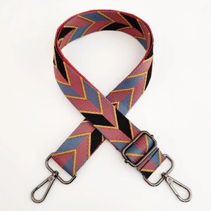 Close-up of adjustable woven shoulder strap with geometric chevron pattern and metal hooks