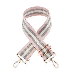 Detail of pink and white striped nylon strap with silver glitter and rose gold metal clips
