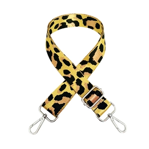 Close-up of leopard print bag strap with silver metal buckles and adjustable length