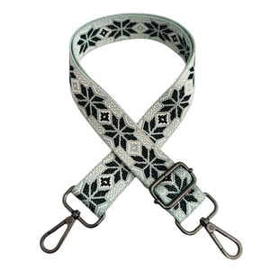 Detail of adjustable geometric snowflake strap with grey metal swiveling hooks
