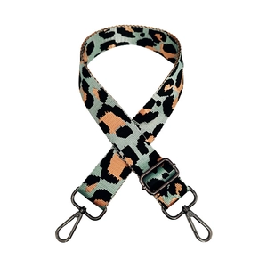 Close-up of leopard print nylon bag strap with gunmetal swivel hooks and adjustable buckle