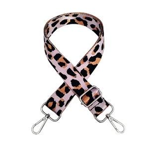 Detail of adjustable leopard print bag strap with silver metal lobster clasps and buckle