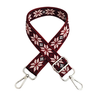 Close-up of snowflake jacquard bag strap with silver metal hooks and buckle