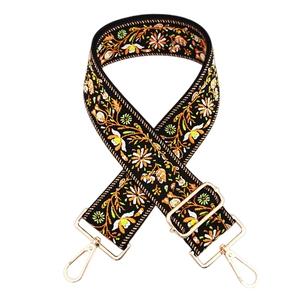 Close-up of ethnic floral embroidery on wide adjustable shoulder strap with gold hooks