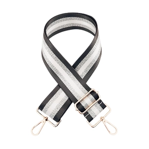 Detail of adjustable bag strap with silver stripe webbing and rose gold hooks
