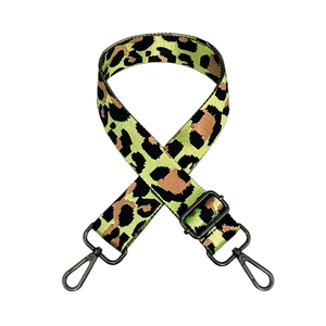 Close-up of adjustable neon green leopard print nylon strap with black metal lobster hooks